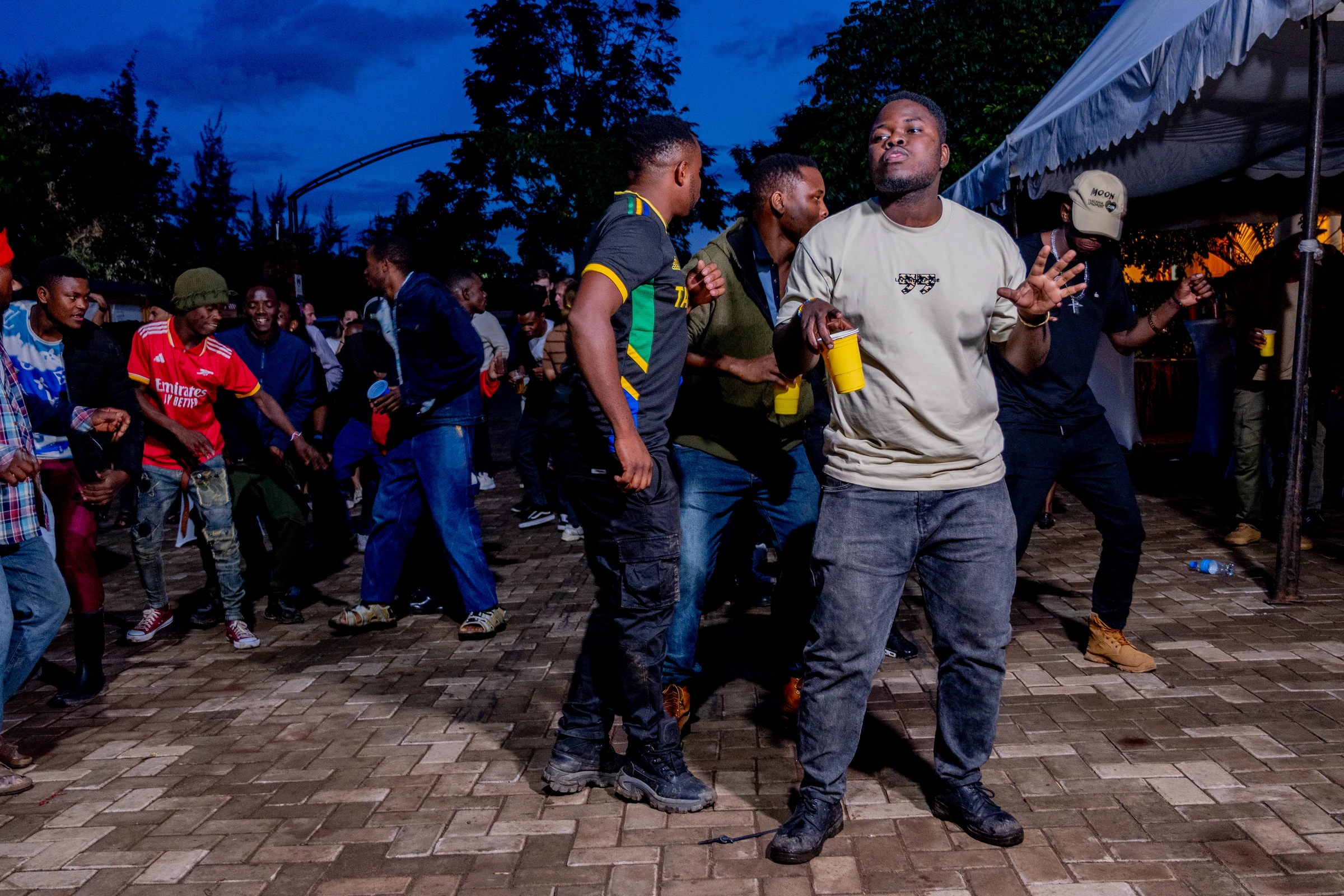 Guests dancing outdoors at dusk